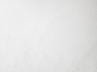 Minimalistic white painted wall texture with slight imperfections.