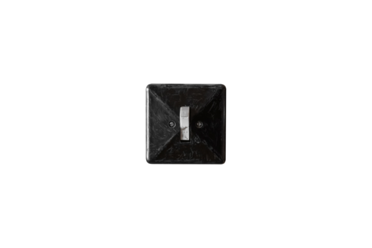 Old black light switch with white toggle is isolated.