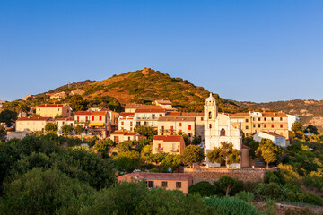 Obraz premium Latin church, in Cargèse, Corsica, France. Typical and picturesque hillside village. Hilltop town nestled on the coast above the Mediterranean sea.