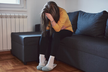 Woman with strong stomach ache, menstrual and digestive issues at home.