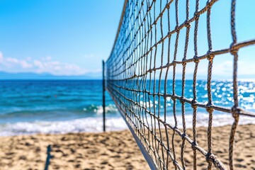Beach volleyball net against a clear blue sea and sky background