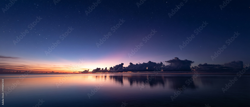 Poster serene twilight sky with stars beginning to twinkle over calm ocean, reflecting soft hues of setting sun. horizon is lined with dark clouds, adding depth to tranquil scene