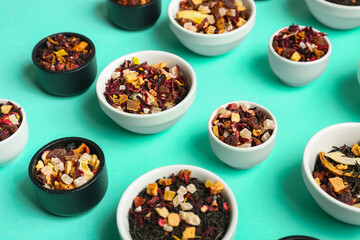Assortment with different types of dried fruit tea on turquoise background