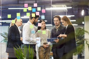 Focused business people team engaged in conversation and negotiation during a meeting in the modern office. Working together and discussing work strategies to foster successful outcomes.