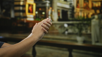 Man clapping hands outdoors in a lively city street setting.