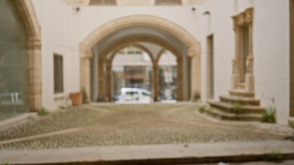 Blurred view of historical university cloisters with stone arches creating an atmospheric backdrop...