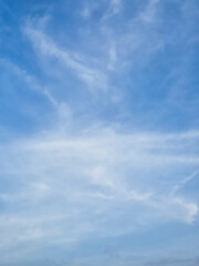 Clear, high-altitude clouds drift across a vibrant azure sky.