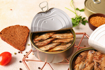 Canned smoked sprats with parsley on white background