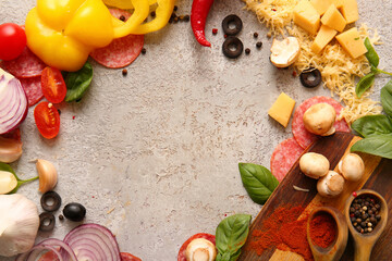 Frame made of ingredients for preparing pizza on grey background