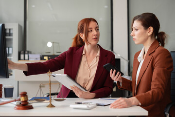 Lawyer businesswoman and two business partners working together in office.