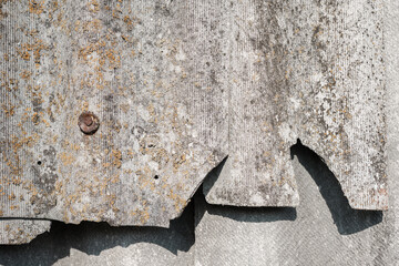 Old and very dangerous asbestos roof. Asbestos dust in the environment. Asbestos removal