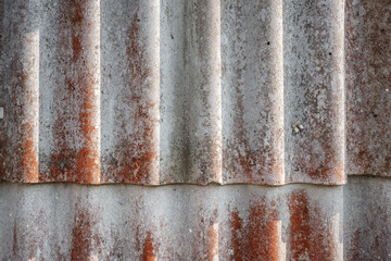 Old and very dangerous asbestos roof. Asbestos dust in the environment. Asbestos removal