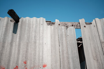 Old and very dangerous asbestos roof. Asbestos dust in the environment. Asbestos removal