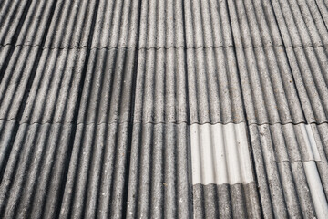 Old and very dangerous asbestos roof. Asbestos dust in the environment. Asbestos removal