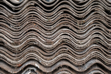 Old and very dangerous asbestos roof. Asbestos dust in the environment. Asbestos removal