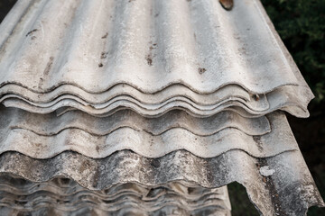 Old and very dangerous asbestos roof. Asbestos dust in the environment. Asbestos removal