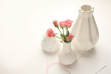 Beautiful bunch of fresh pink roses in full bloom against white background. Bouquet of flowers. Copy space for text. Valentine's day or Mother's day card.