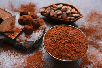 Bowl with cocoa powder on black background