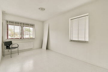 Bright, minimalist interior showcasing a simple room design featuring a chair, window with blinds,...