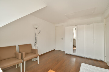 A spacious and bright interior featuring minimalist furniture, warm wooden flooring, and ample natural light, perfect for contemporary living.