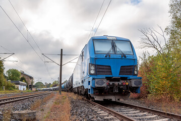 Fototapeta premium Train electric locomotive carrying fuel storage tanks, in Baden Wurttemberg, Germany