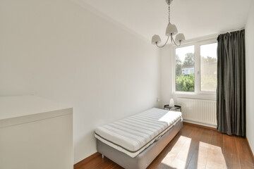A bright and airy minimalist bedroom featuring a simple bed, large windows, and neutral tones. Perfect for relaxation and tranquility.