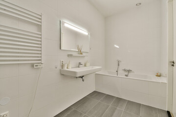 A contemporary bathroom featuring a sleek vanity, minimalist mirror, and elegant bath fixtures, highlighted by bright, clean lines and spacious layout.