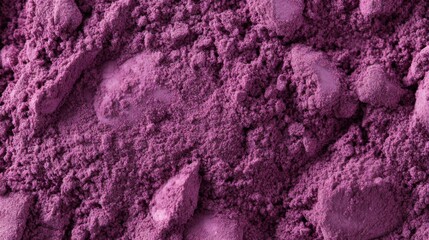 Bright purple powder scattered on a surface, showcasing its fine texture and vibrant hue in a well-lit setting