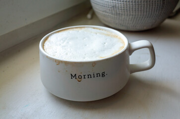 White coffee mug with the word morning written on it