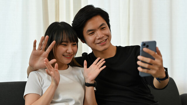 A Close-up image of An Asian Couple Video Calling at Home