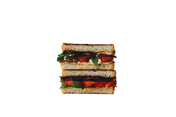 Stacked Grilled Sandwich: Roasted Vegetables, Greens, and Tomatoes on White Bread.