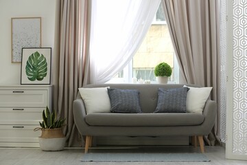 Beautiful curtains on window in stylish living room interior