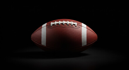 A football is placed on a dark black background.