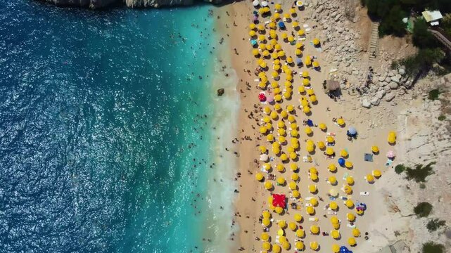 Antalya, August 2024:People sunbathe and swim at Kaputaş beach in Turkey on the Mediterranean coast.A beach with turquoise sea waters from a bird's-eye view, between the towns of Kash and Kalkan.Drone