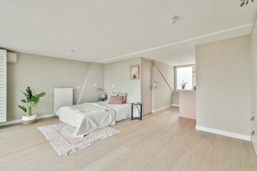 A serene and stylish bedroom featuring a cozy bed, soft textiles, and a touch of greenery, promoting a peaceful atmosphere.