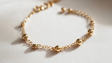 Fototapeta premium A trendy charm bracelet placed on a neutral, matte surface, with room for product descriptions.