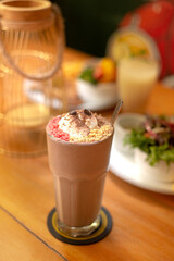 a glasses choco milk shake with vanilla ice cream as topping and marsmellow. Perfect for advertising, book menu and commercial purpose