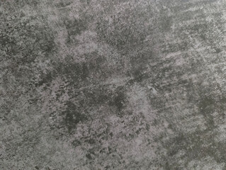 An old worn-out gray wall. Grey background with damage. Grey texture.