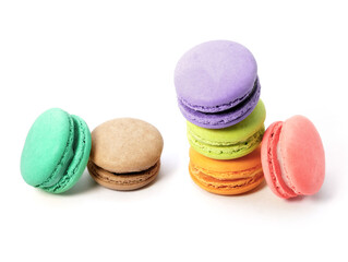 Pile of macaron cookies in various flavours and colours isolated on white background.