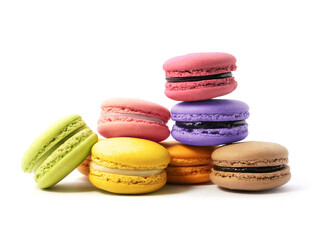Pile of macaron cookies in various flavours and colours isolated on white background.