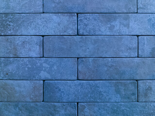 Fototapeta premium The brick wall is blue. Brick background. The texture of the blue brick.