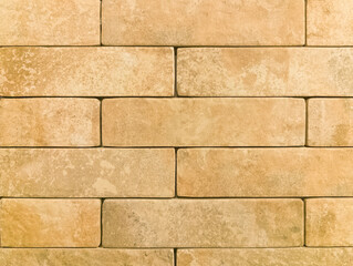 The brick wall is yellow. Brick background. The texture of the yellow brick. Brickwork.