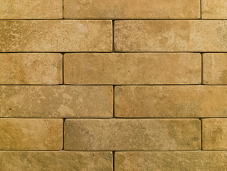 The brick wall is yellow. Brick background. The texture of the yellow brick.