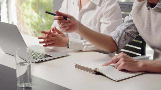 Teammate coworkers gather in boardroom discuss ideas in group at briefing about discussing investment portfolio, planning and analyzing strategies with client