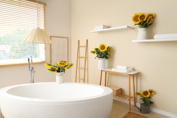 Beautiful bouquets of sunflowers in bathroom