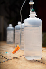 medicine bottle and syringe. infusion bags standing in a row with dark background. 