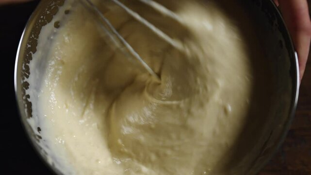 Close-up of pancake batter being mixed in kitchen bowl.