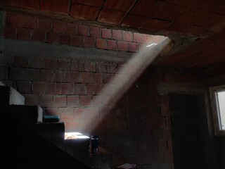 Sun rays falls on the concrete stairs in new build house