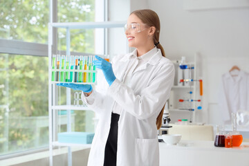 Female chemist with test tubes in laboratory