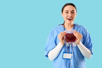 Surprised female doctor with blood pack for transfusion on blue background